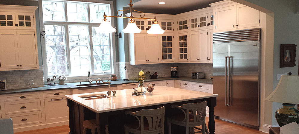 Stunning white painted inset kitchen cabinetry from Levant Kitchens, with the Island by Harlan Cabinetry.